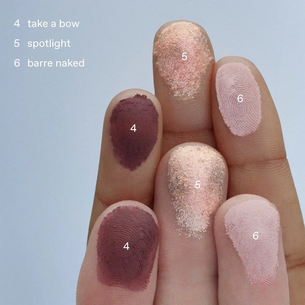 Fingertips swatched with take a bow deep plum matte, spotlight peachy shimmer, and barre naked soft pink matte.
