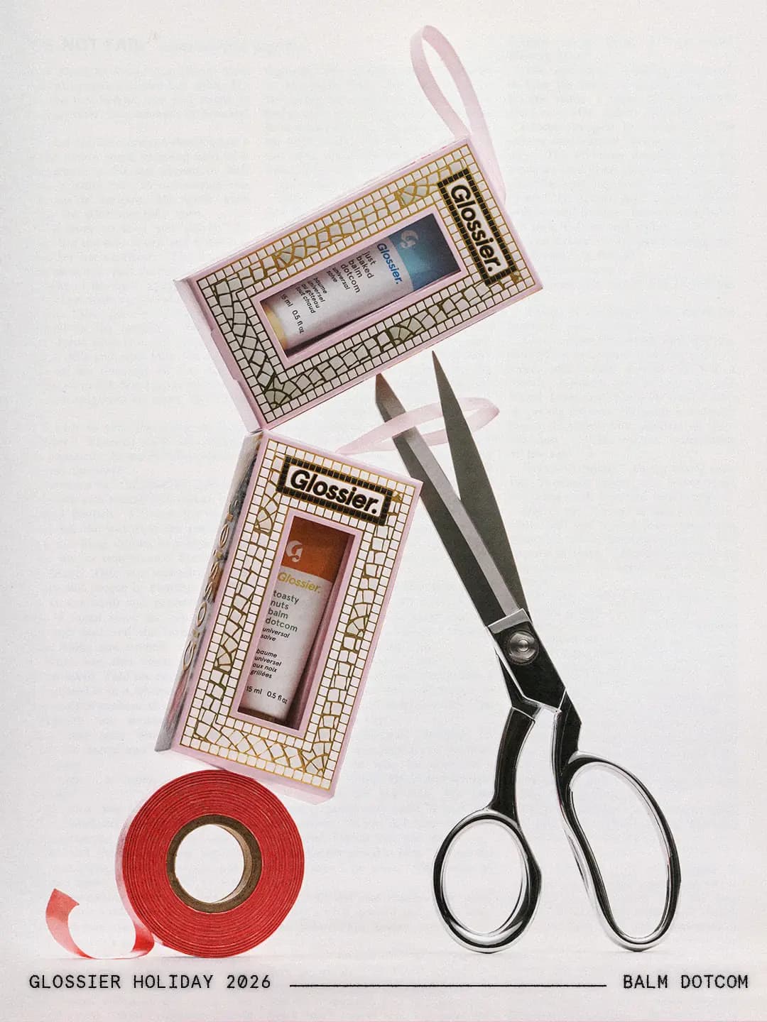 Just Baked and Toasty Nuts Balm Dotcom boxes balanced on red ribbon spool and silver scissors