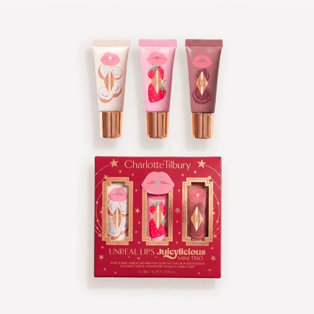 Unreal Lips Juicylicious Mini Trio: coconut, strawberry and fig-print lip tubes above a red star-patterned box