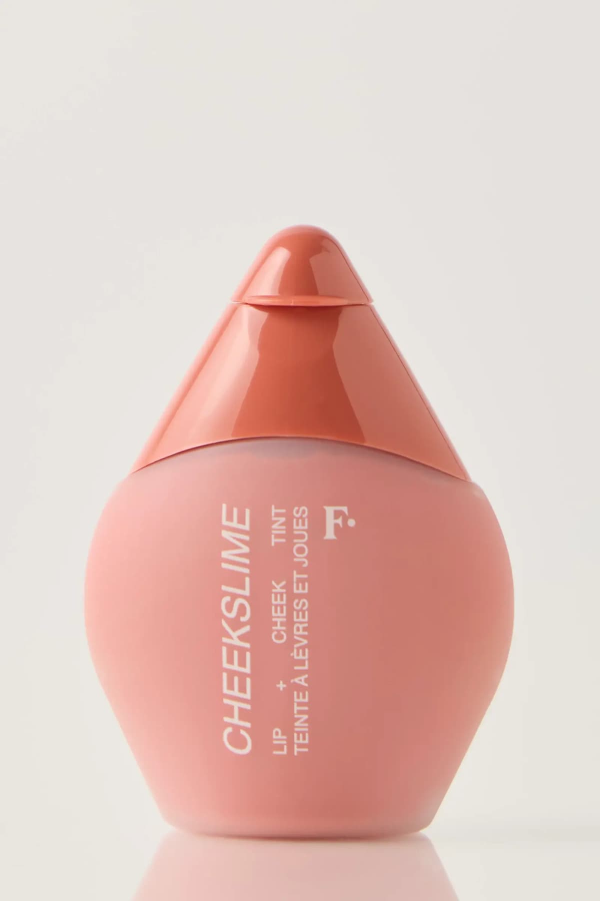 Freck Cheekslime lip and cheek tint in a pink teardrop bottle with glossy terracotta cap