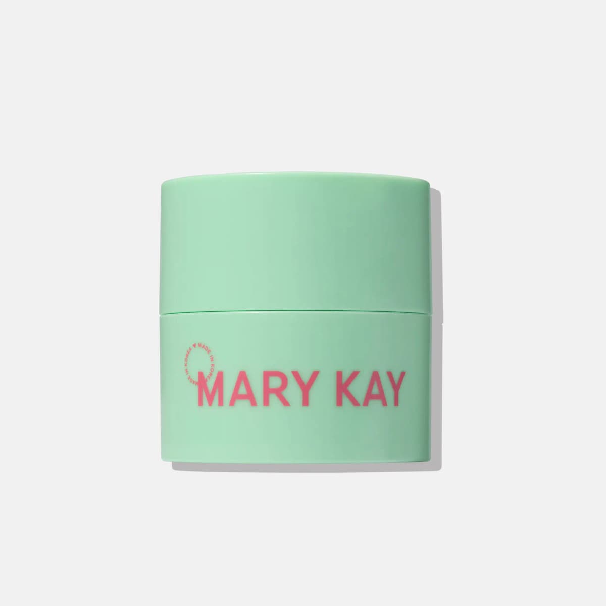 Mint green Mary Kay Melt-In Cleansing Balm jar with pink logo and made in Korea mark on a grey background