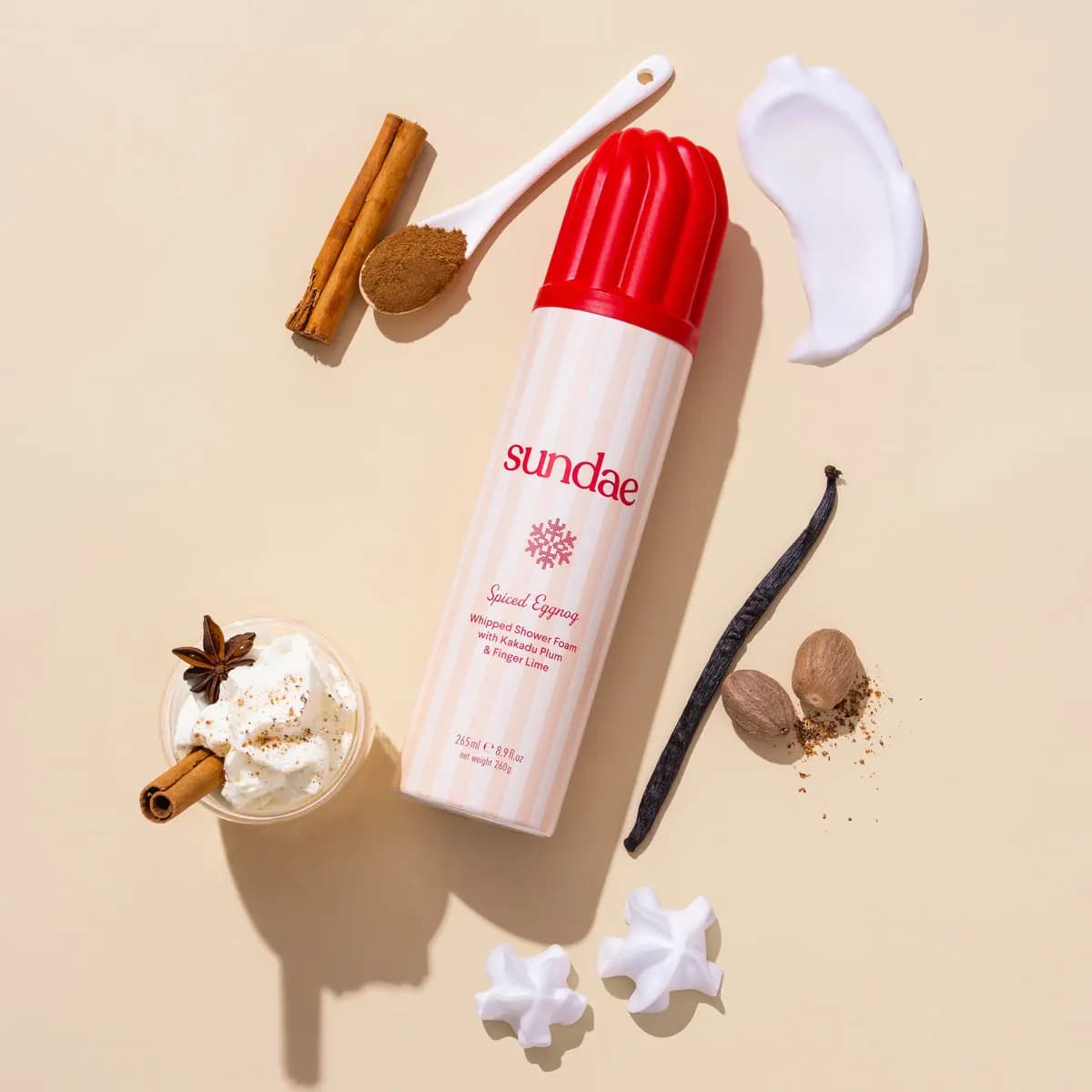 Spiced Eggnog foam in cream-striped can with spoon of spice, cinnamon, nutmeg, vanilla pod and white foam swatch