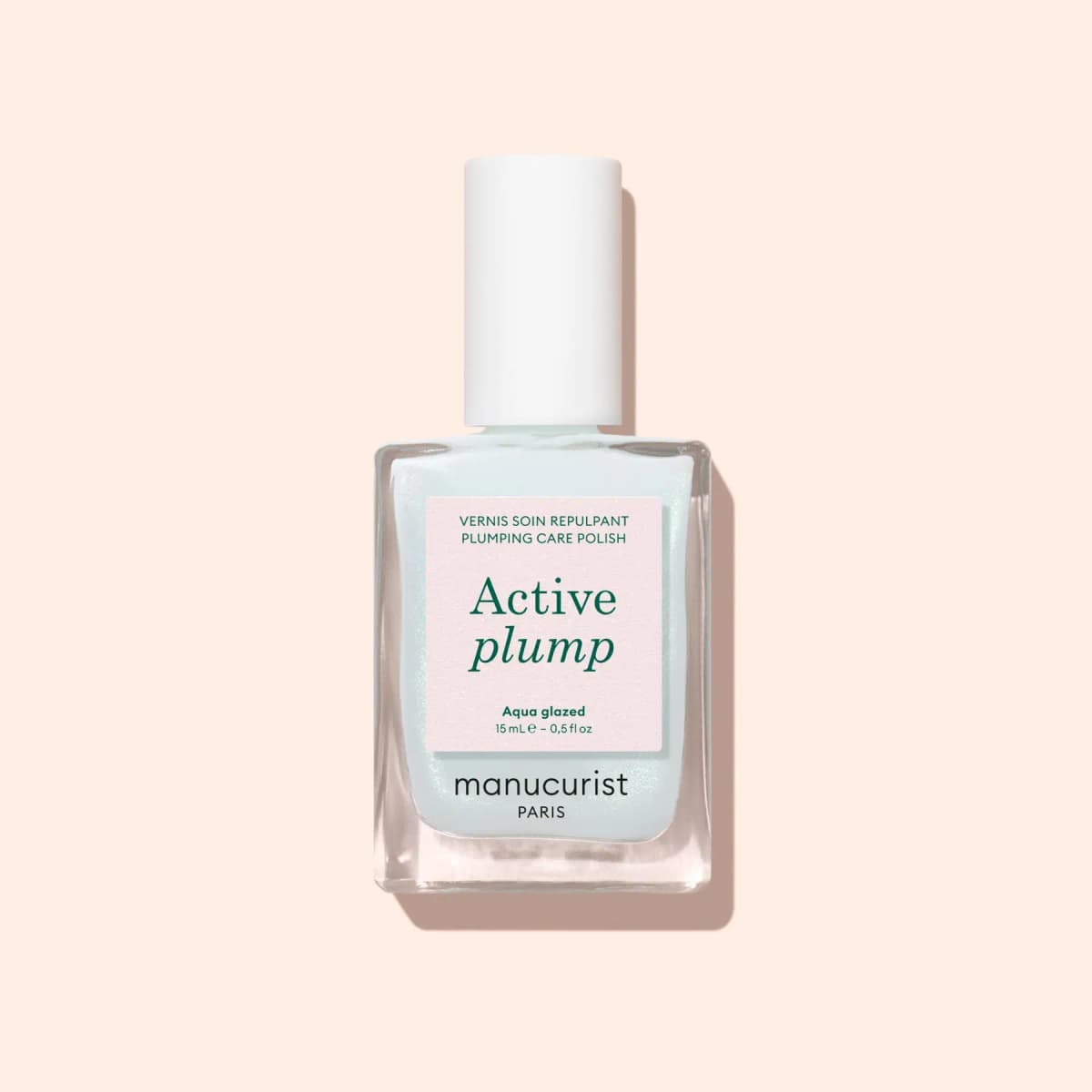 Manucurist Active Plump plumping care polish bottle in shimmery Aqua Glazed on a peach background