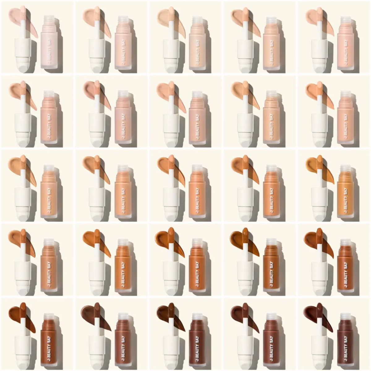 Grid of 25 concealer shades from fair to deep, each open bottle shown with its applicator and a matching swatch