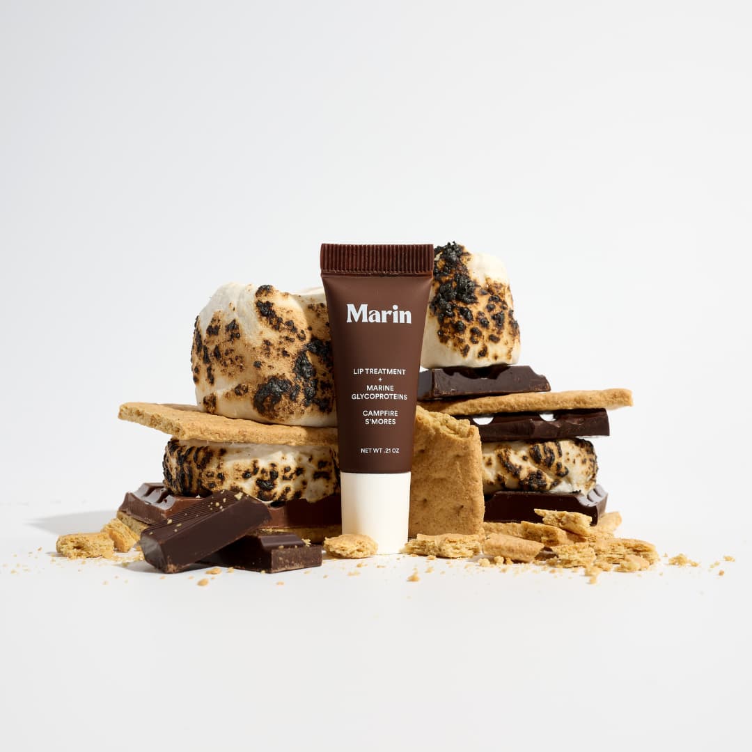 Dark brown Campfire S'mores tube amid toasted marshmallows, graham crackers and chocolate