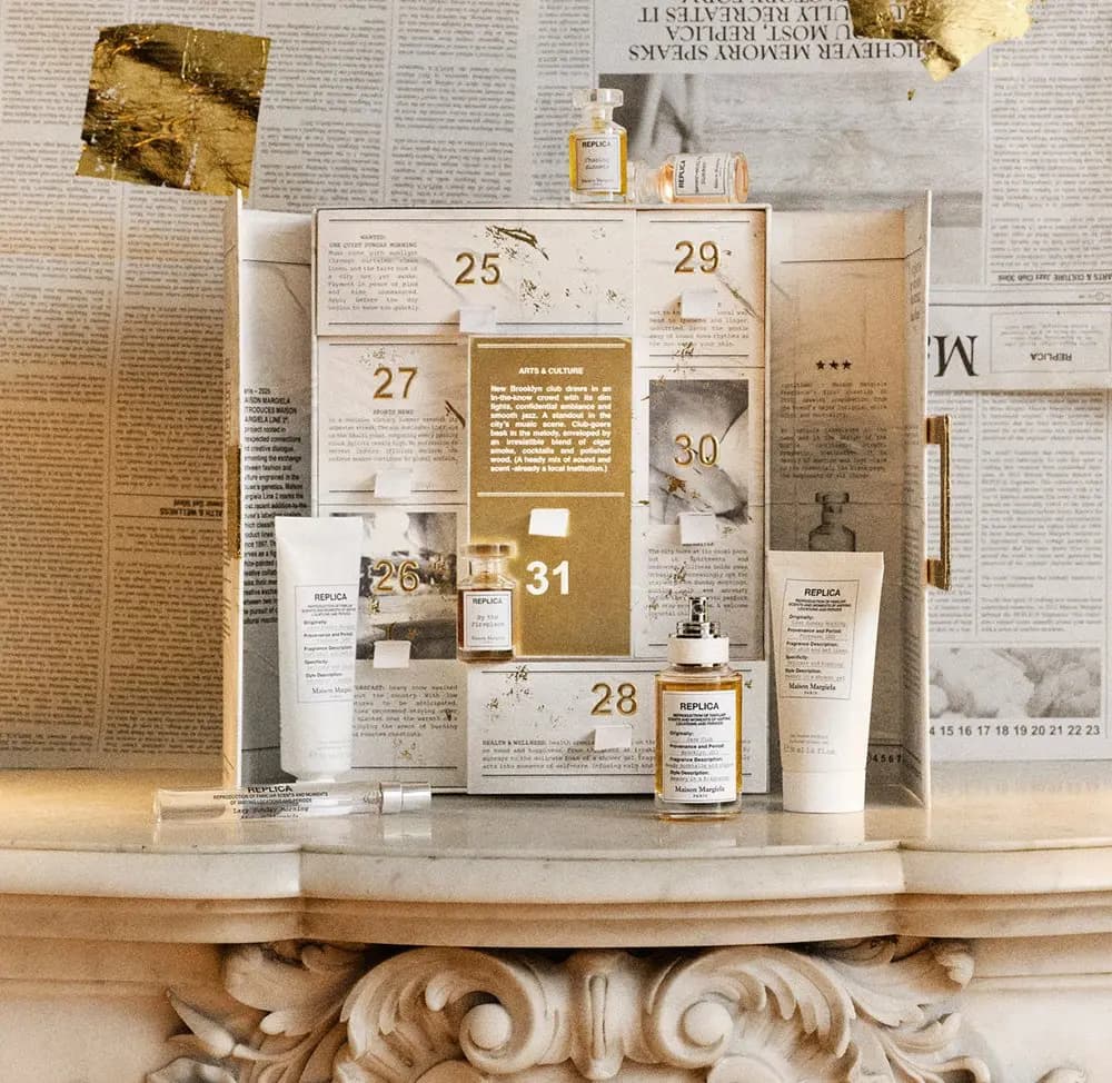 Open calendar on a carved marble mantel with Jazz Club, By the Fireplace, a travel spray and two white tubes