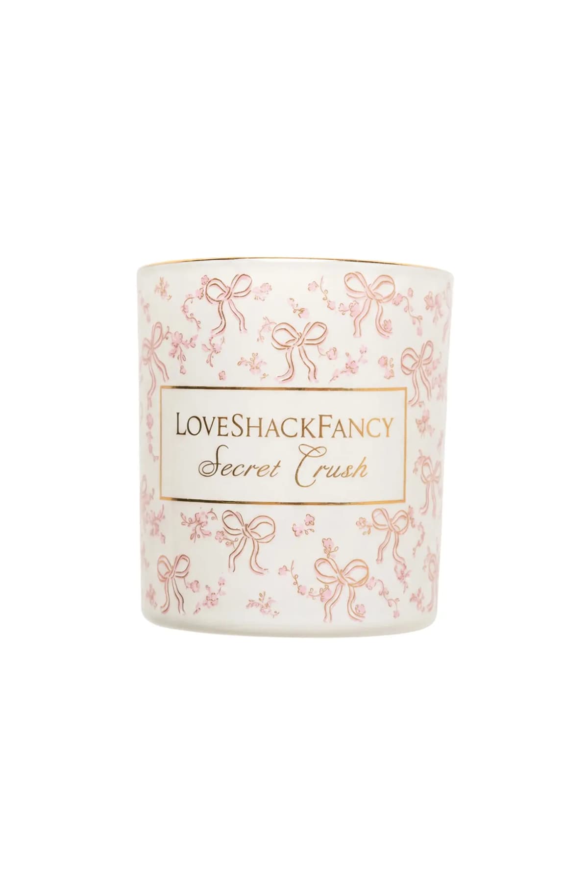 Secret Crush candle in a white vessel with pink-and-gold Coquette Bow print and gold rim, shown on a white background