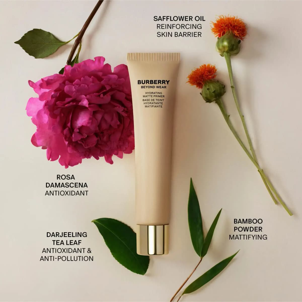 Primer tube surrounded by pink peony, orange safflowers, tea leaves and bamboo with ingredient labels