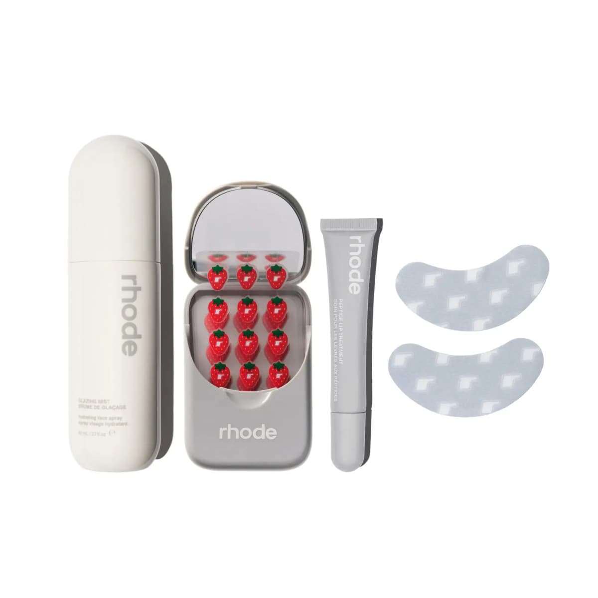 The On-The-Go Set: white Glazing Mist bottle, open Spot Case, grey Peptide Lip Treatment tube and two grey eye patches