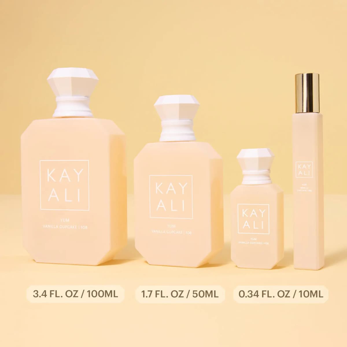 Lineup of 100ml, 50ml and 10ml cream bottles plus a slim gold-capped travel spray, with sizes labelled below