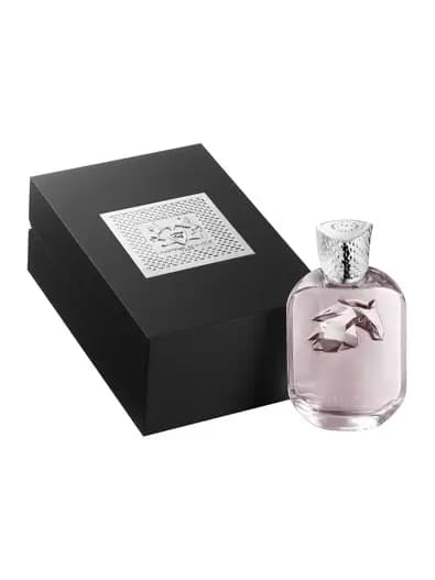 Pale pink bottle beside a black gift box with an embossed silver crest plaque on the lid