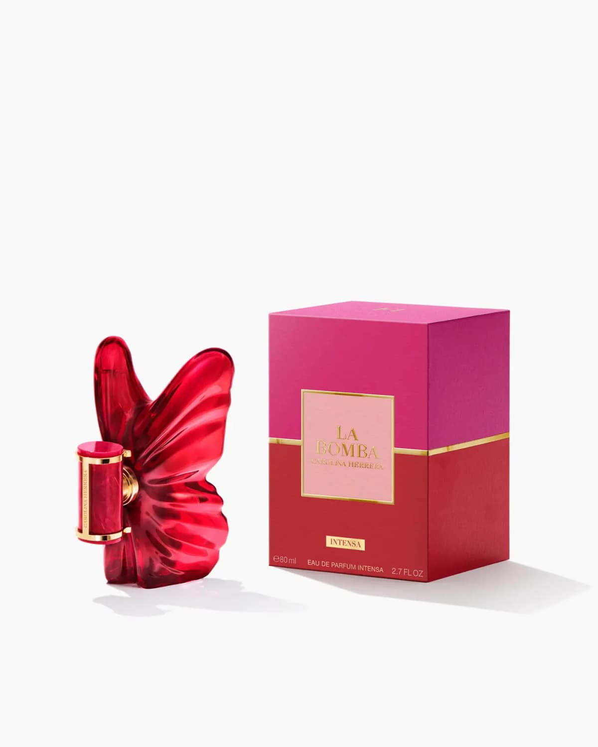 La Bomba Intensa bottle beside its pink and red 80ml Eau de Parfum Intensa box with gold trim on white