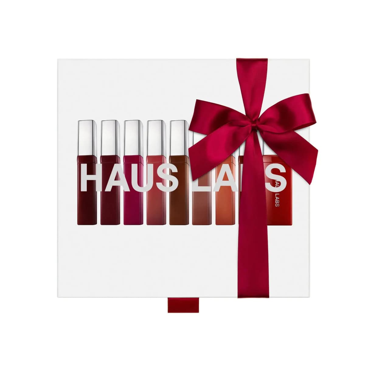 White Atomic Shake Vault box printed with nine lacquer tubes and HAUS LABS lettering, tied with a crimson ribbon