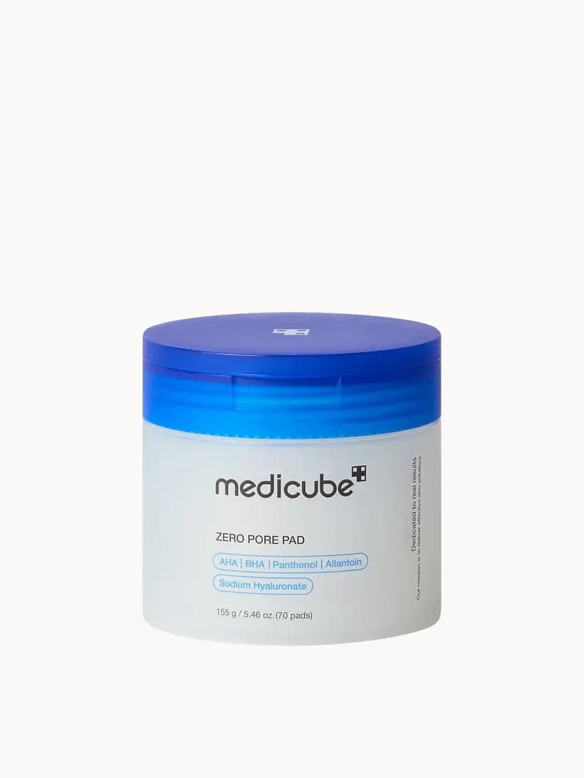 Frosted round tub with bright blue lid labelled Medicube Zero Pore Pad with AHA, BHA, Panthenol and Allantoin