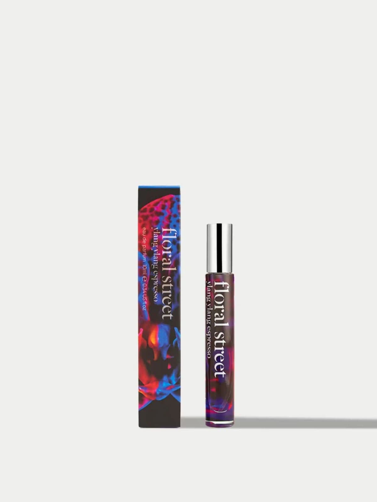 Floral Street Ylang Ylang Espresso 10ml eau de parfum rollerball with silver cap next to its red and blue floral box