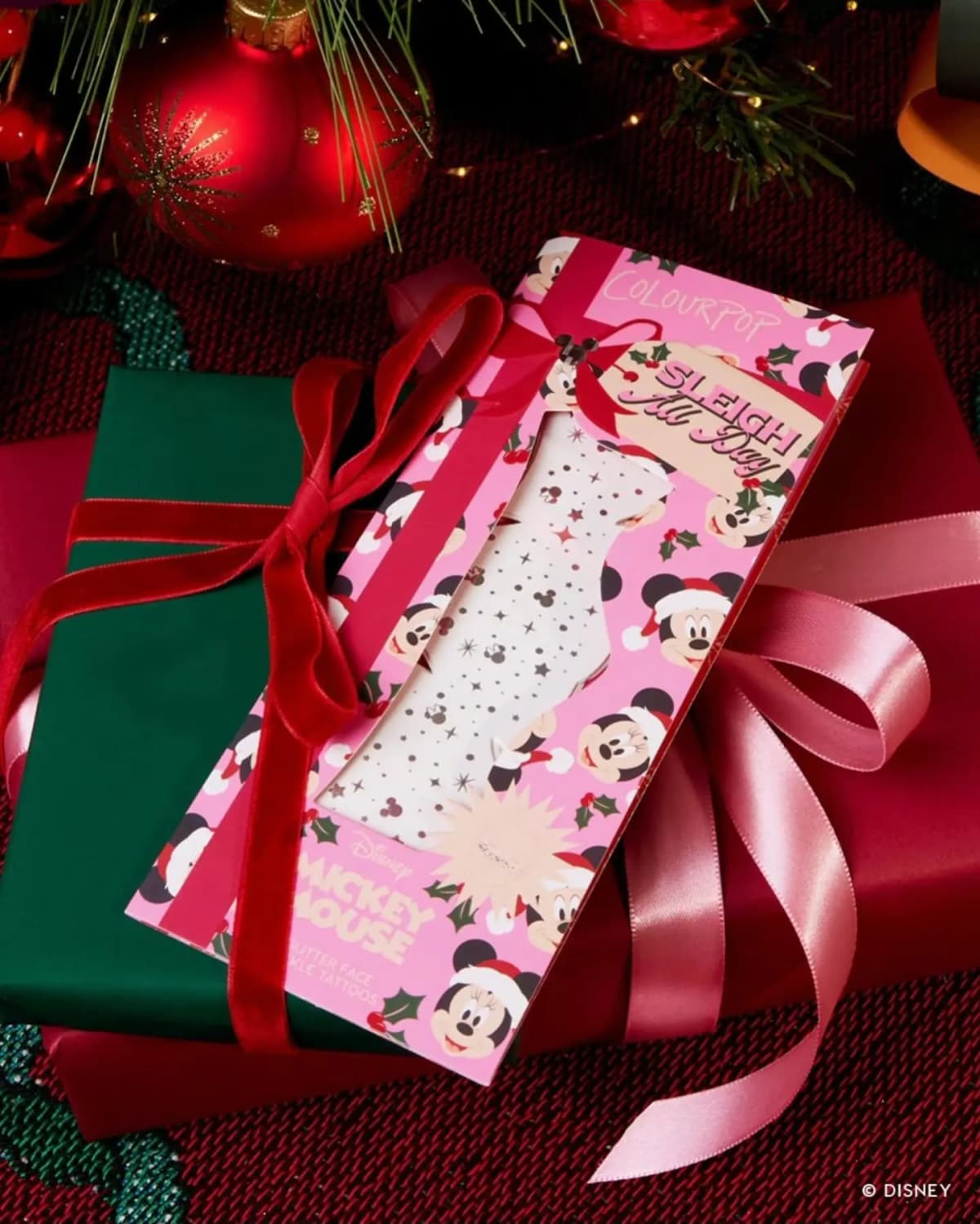 Pink Sleigh All Day glitter face freckle tattoos pack on a wrapped gift with red velvet and pink satin ribbons
