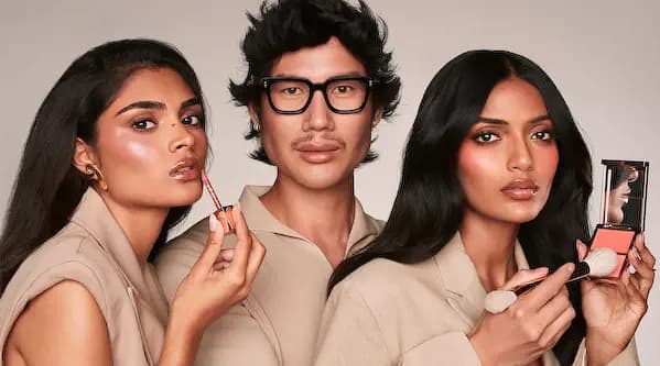 Patrick Ta with two models holding a Major Volume Plumping Gloss and a Major Headlines blush duo