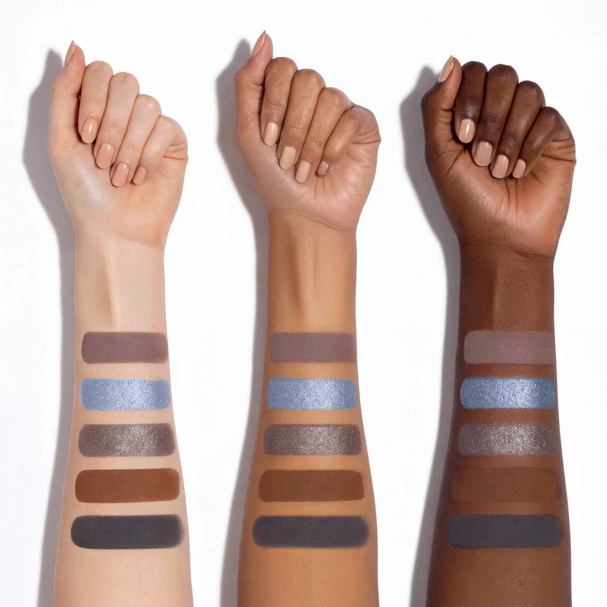 Three arms from light to deep skin tones swatched with the five shades: mauve-brown, icy blue, taupe shimmer, brown
