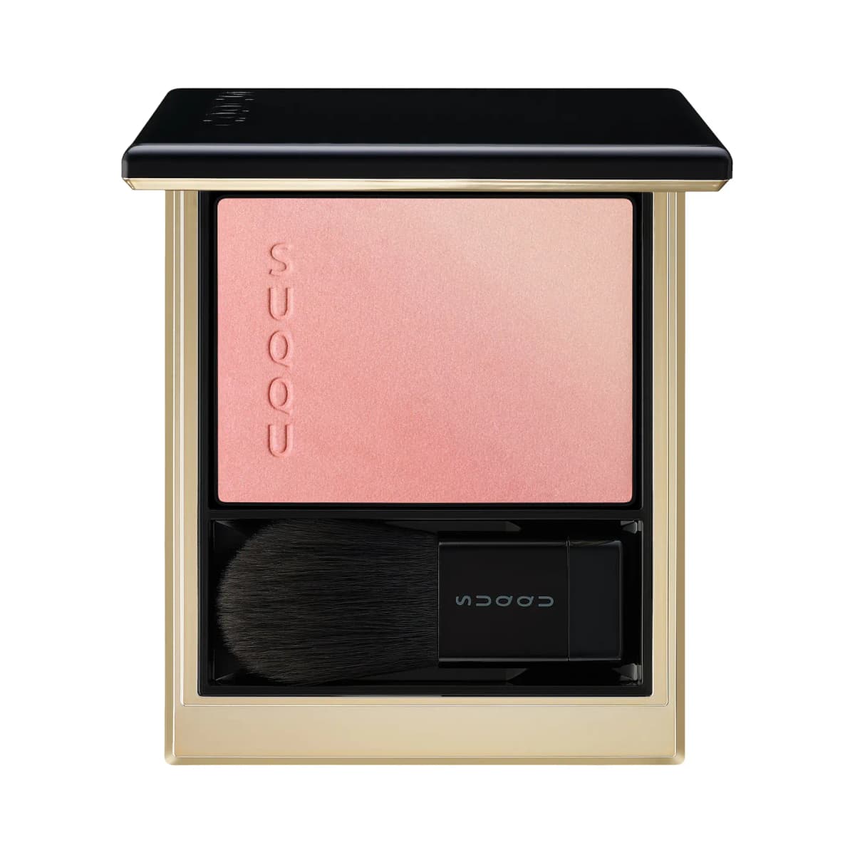 Blush compact with a coral-pink to peach gradient pan and a black-handled brush