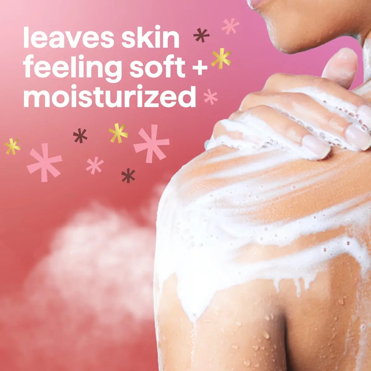 Person lathering white foam over a shoulder beside text "leaves skin feeling soft + moisturized" on a pink background