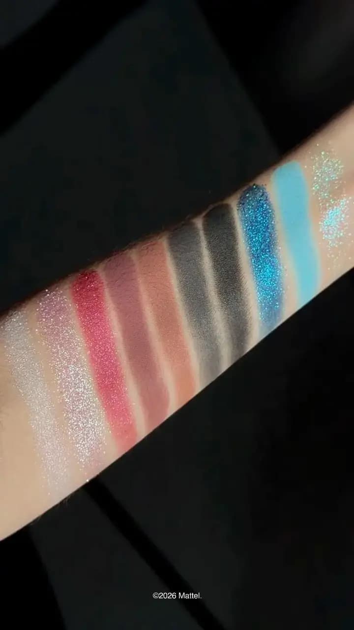 Arm swatches of all ten shades: aqua glitter, matte blue, sparkly cobalt, blacks, greys, nudes, mauve, raspberry, pink, white