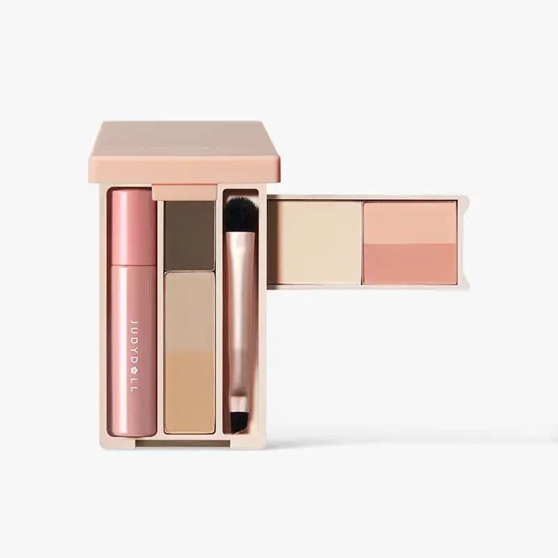 JUDYDOLL Mini Makeup Palette open in pink compact showing eyeshadow, brow shades, applicator brush, highlighter and blush