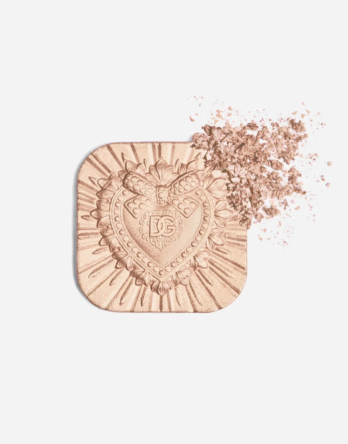Peach-champagne highlighter pan out of its case, with a crumbled corner of glowing powder