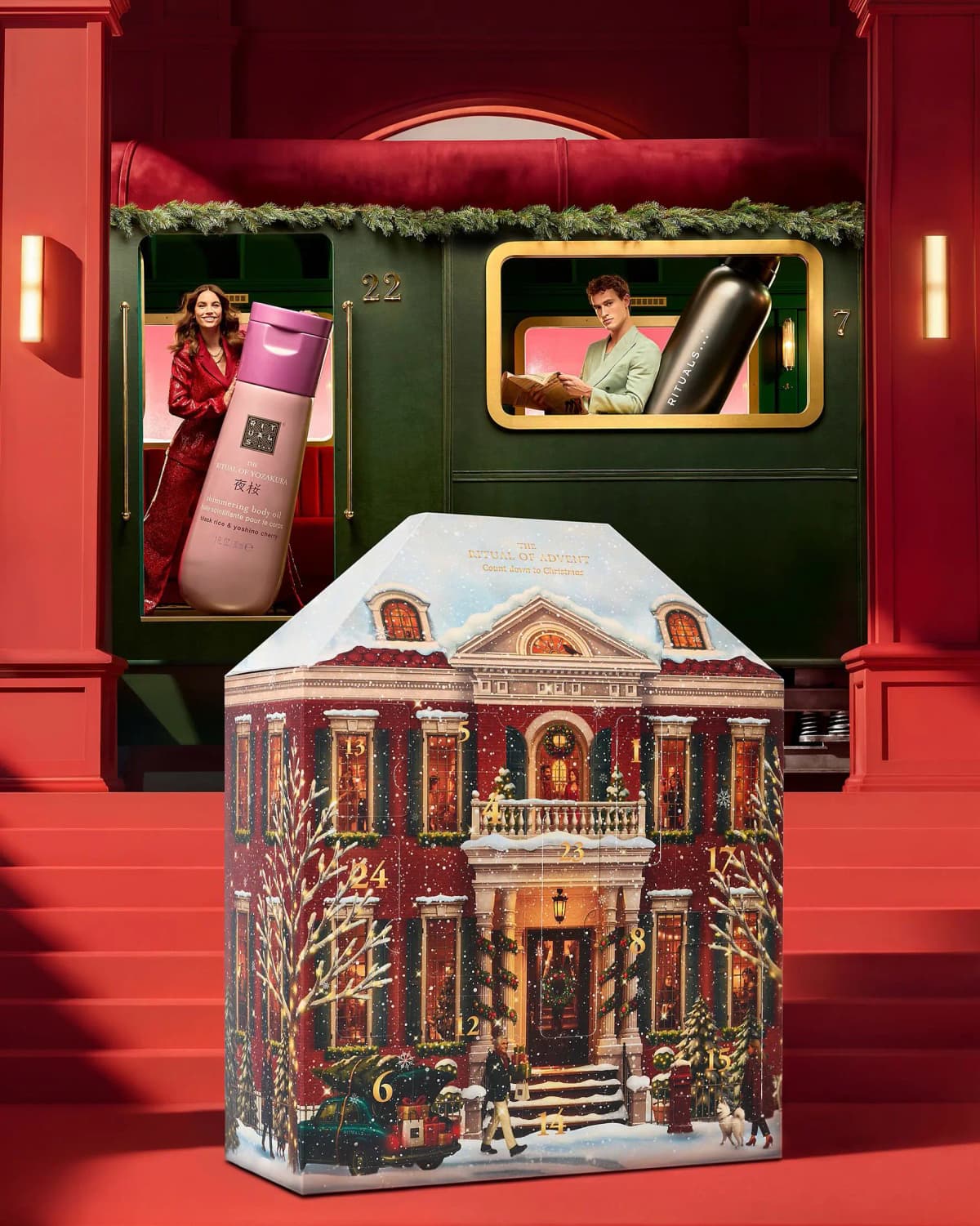 Rituals Classic Advent Calendar 2026 townhouse box before a green train carriage with models holding giant bottles