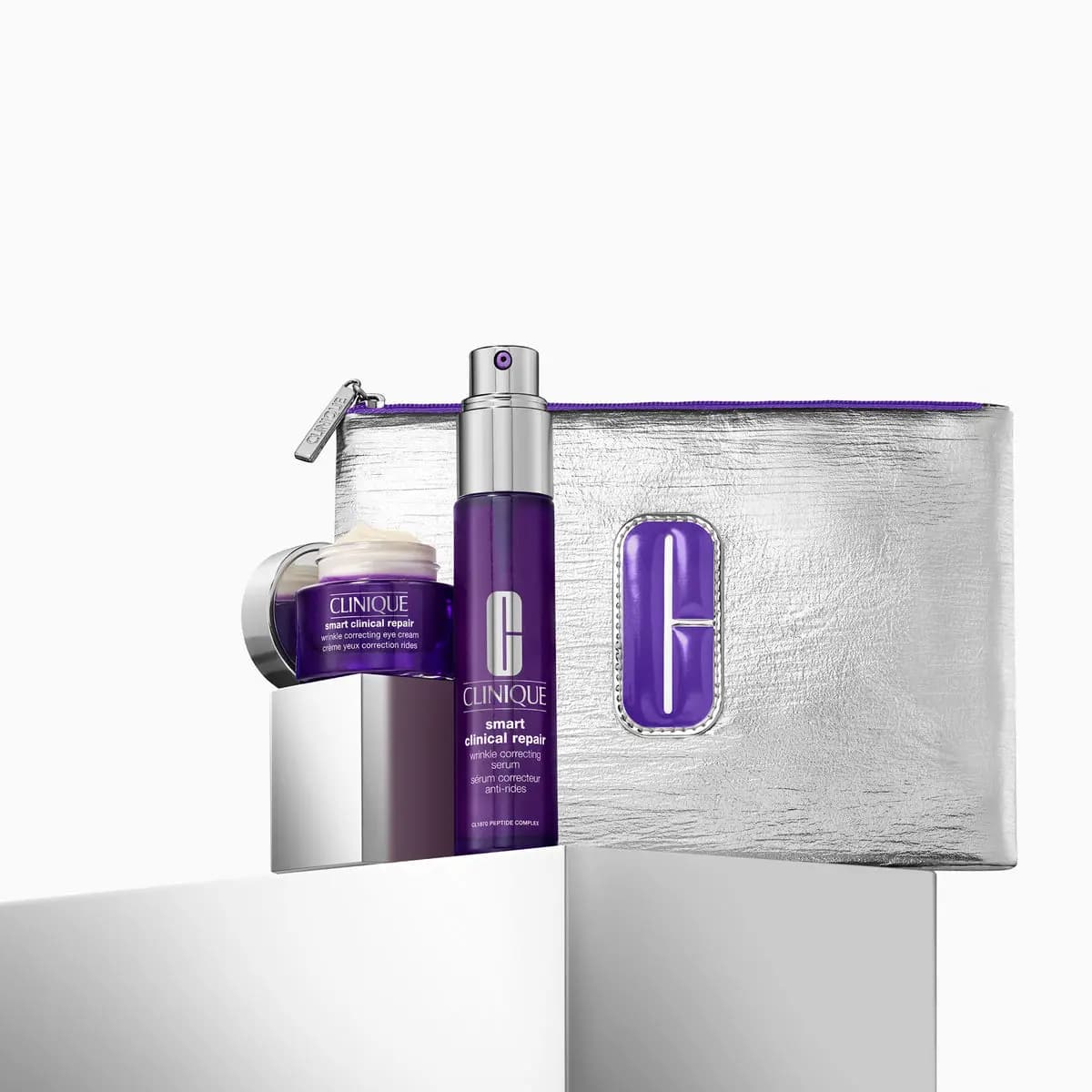 Smart Clinical Repair wrinkle correcting serum and eye cream with a silver pouch bearing a purple C logo