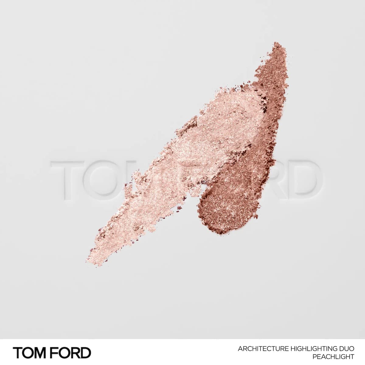 Crushed Peachlight swatches of pale pink and deeper rose-copper shimmer powder on a white Tom Ford embossed surface.