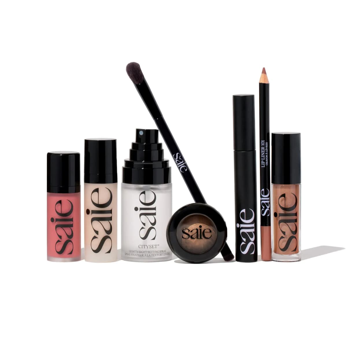 Saie blush, gel, Cityset spray, brush, Gelato eyeshadow, mascara, Lip Liner 101 and lip oil on white backdrop