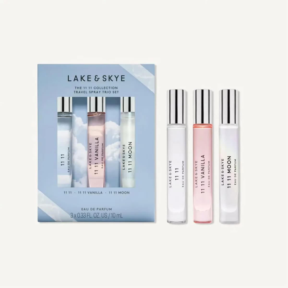 Lake & Skye 11 11 Collection Travel Spray Trio Set box beside three silver-capped perfume bottles on a cream background.