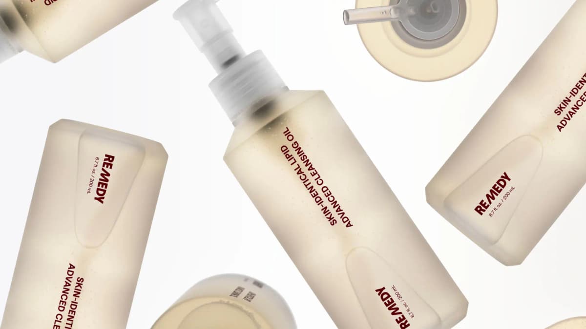Several frosted Remedy bottles with maroon labels scattered at angles on a white background, one seen from above