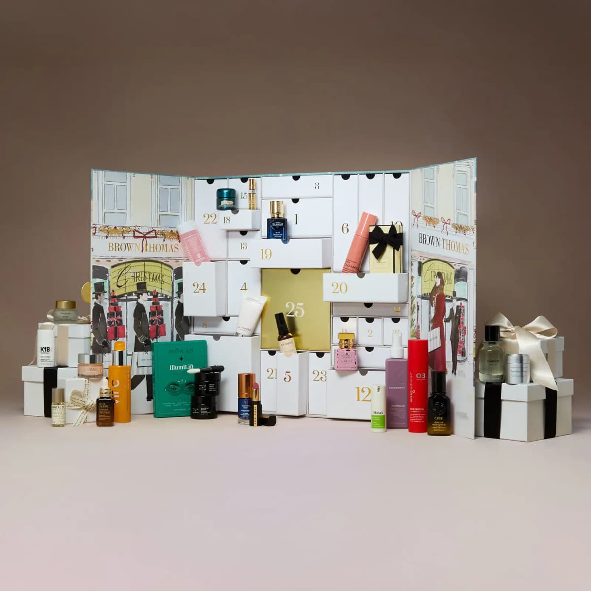 Open Brown Thomas advent calendar with numbered white drawers surrounded by luxury skincare, fragrance and haircare products.
