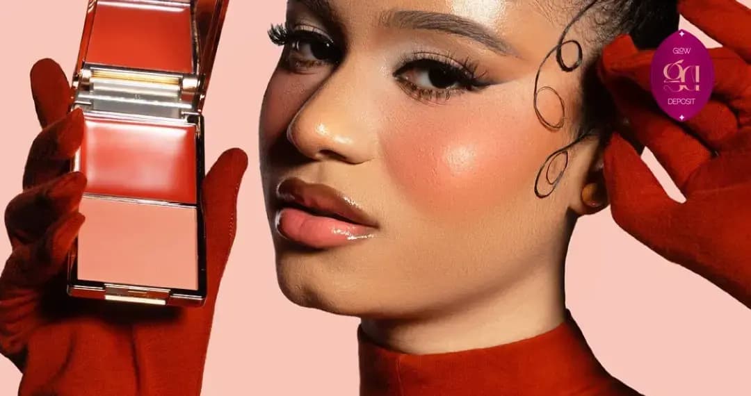 Model with sculpted curl detailing and red gloves holds an open red and peach duo, wearing a glowing peachy blush