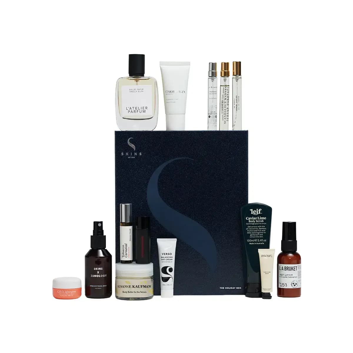 Navy Skins box with L'Atelier Parfum bottle, Omorovicza tube, Leif scrub, L:A Bruket lotion and minis on white