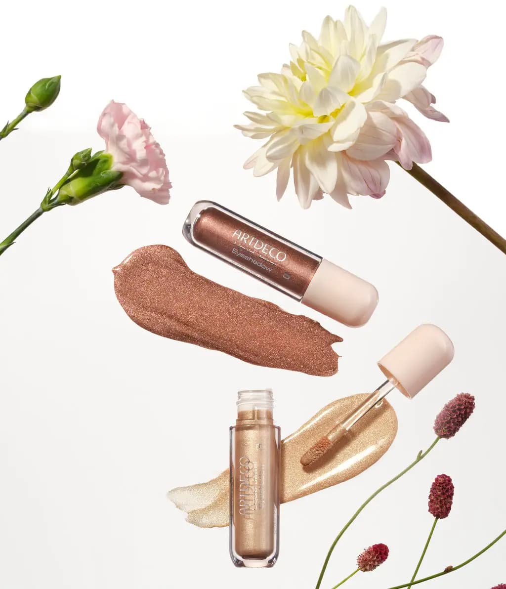 Two Liquid Jewel Eyeshadows with bronze and gold shimmer swatches among carnation, dahlia and burnet flowers
