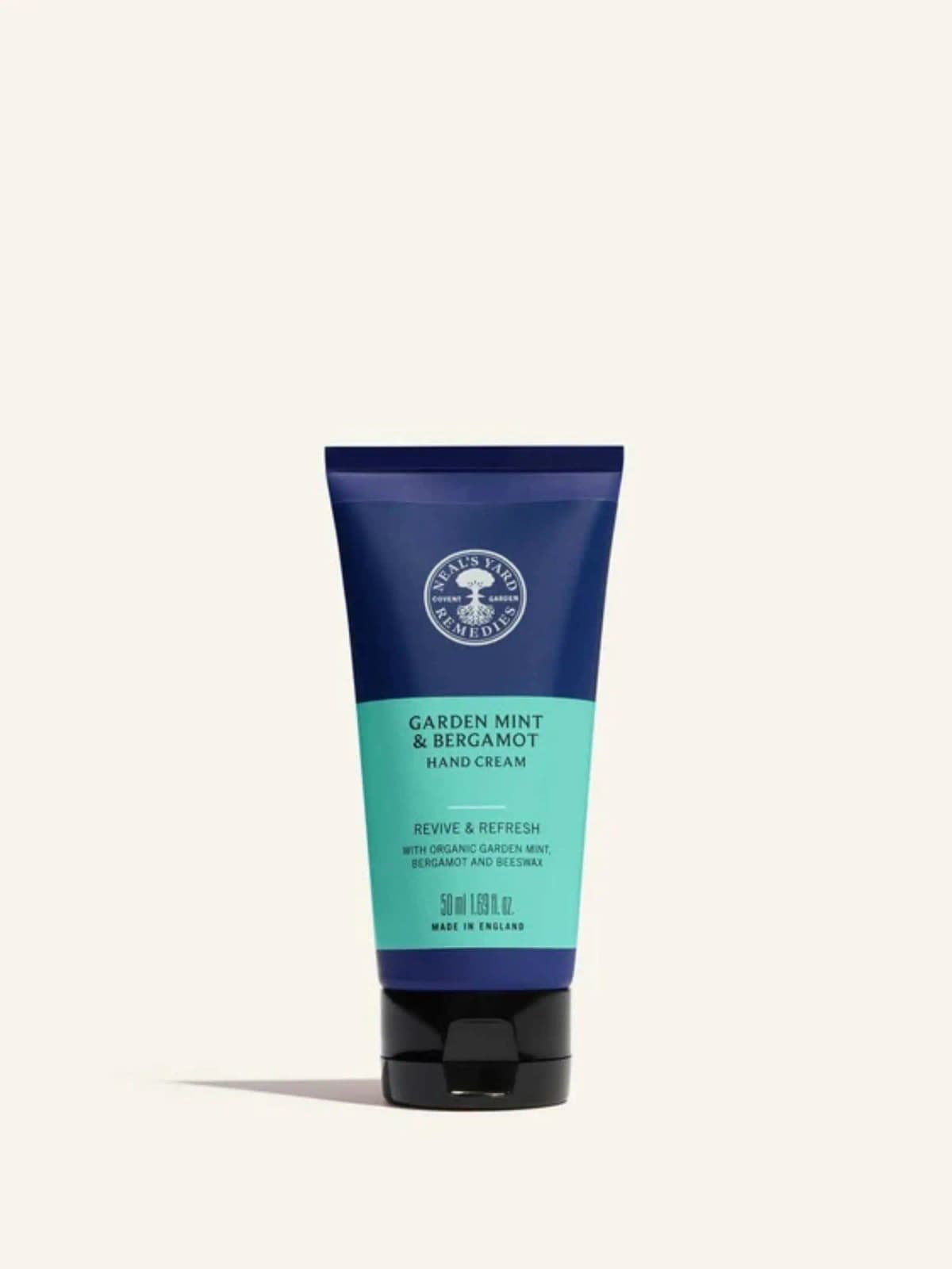 Neal's Yard Remedies Garden Mint & Bergamot Hand Cream 50ml in a navy and turquoise tube with black flip cap