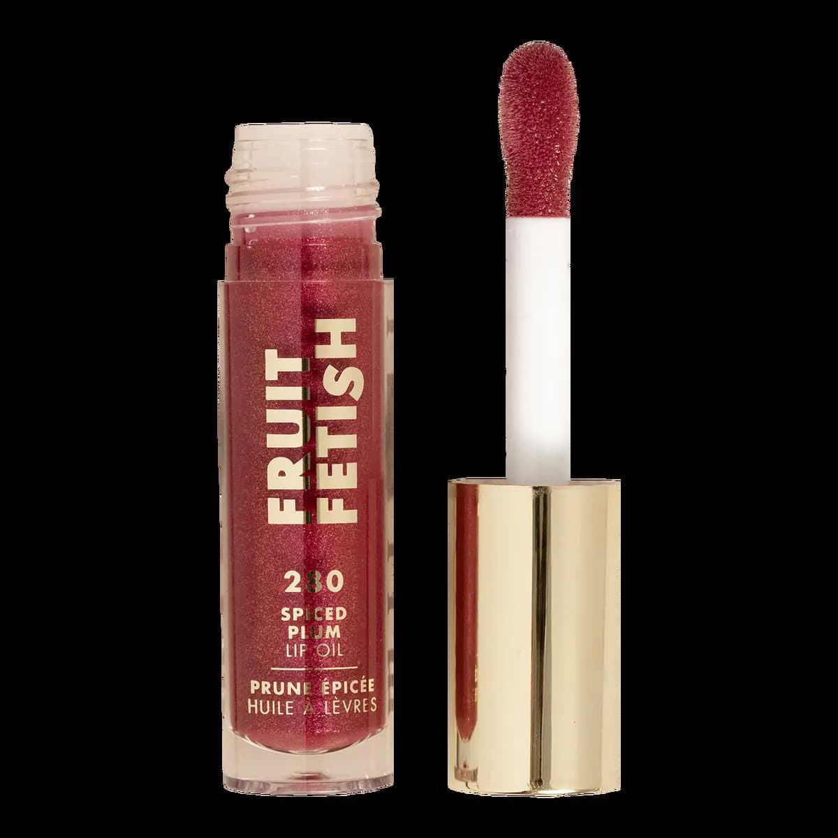Open 280 Spiced Plum tube of berry-red shimmer oil with a plum-tinted applicator on a gold cap