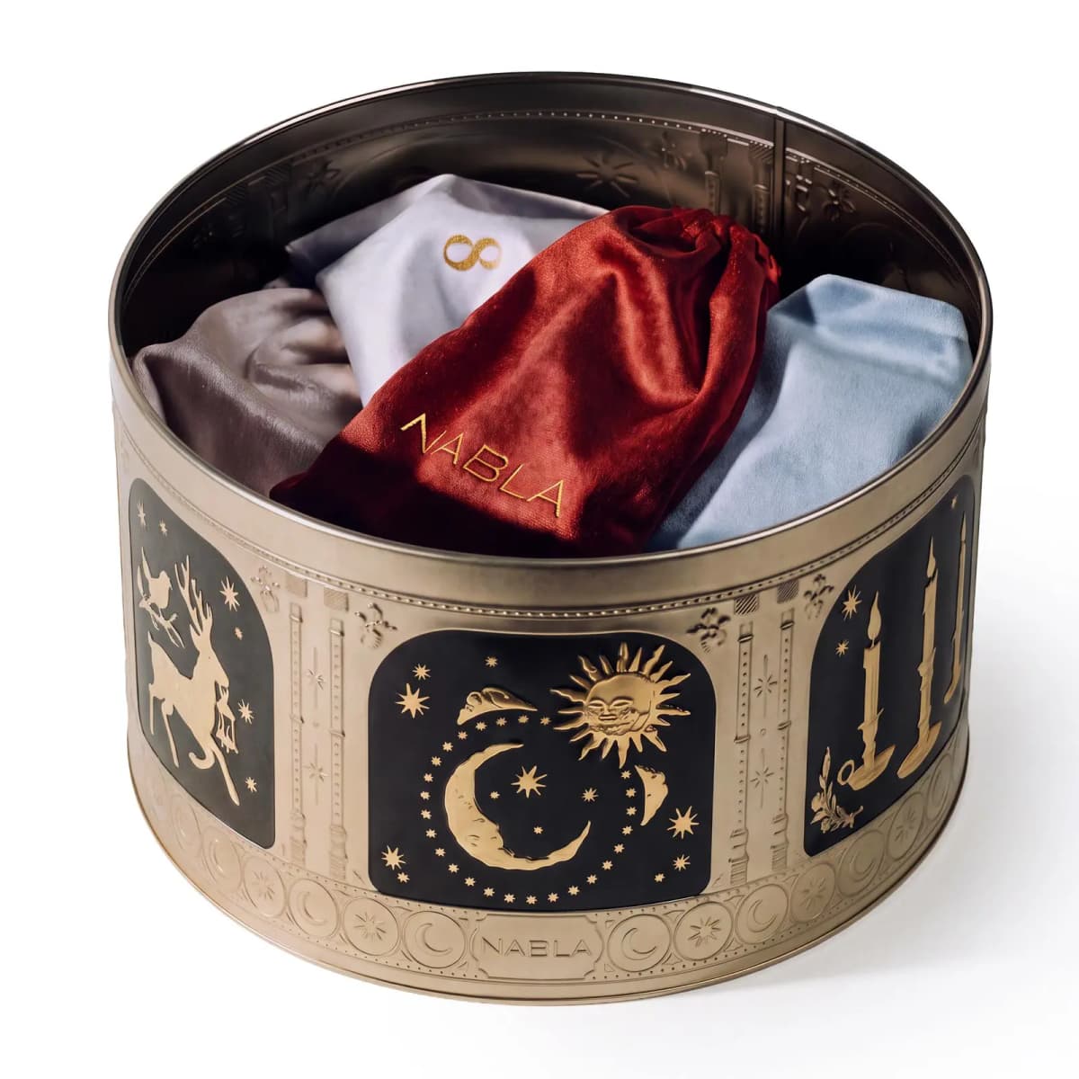 Open gold tin filled with velvet pouches in rust red, grey, lilac and pale blue, one stamped NABLA