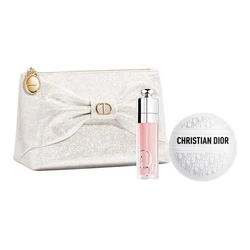 Ivory glitter pouch with draped bow and gold CD clasp beside a pink Dior lip gloss and white Christian Dior sphere
