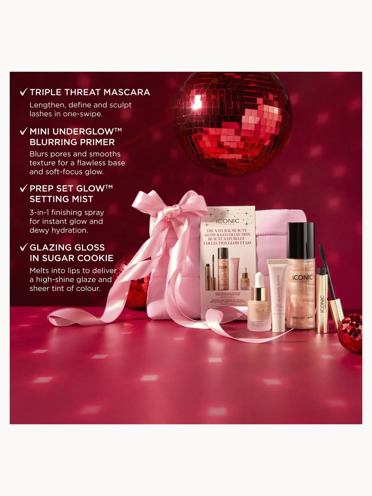 Pink-ribboned Natural Beauty Glow & Go set on red backdrop with disco ball, listing mascara, primer, setting mist