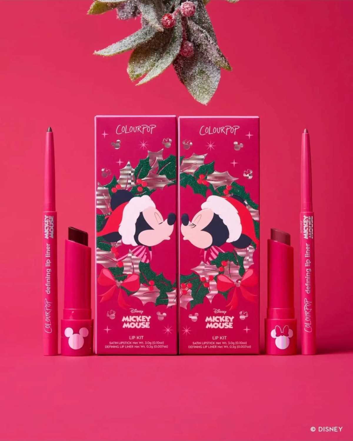 Two Mickey Mouse lip kit boxes showing Mickey and Minnie kissing, with berry satin lipsticks and lip liners