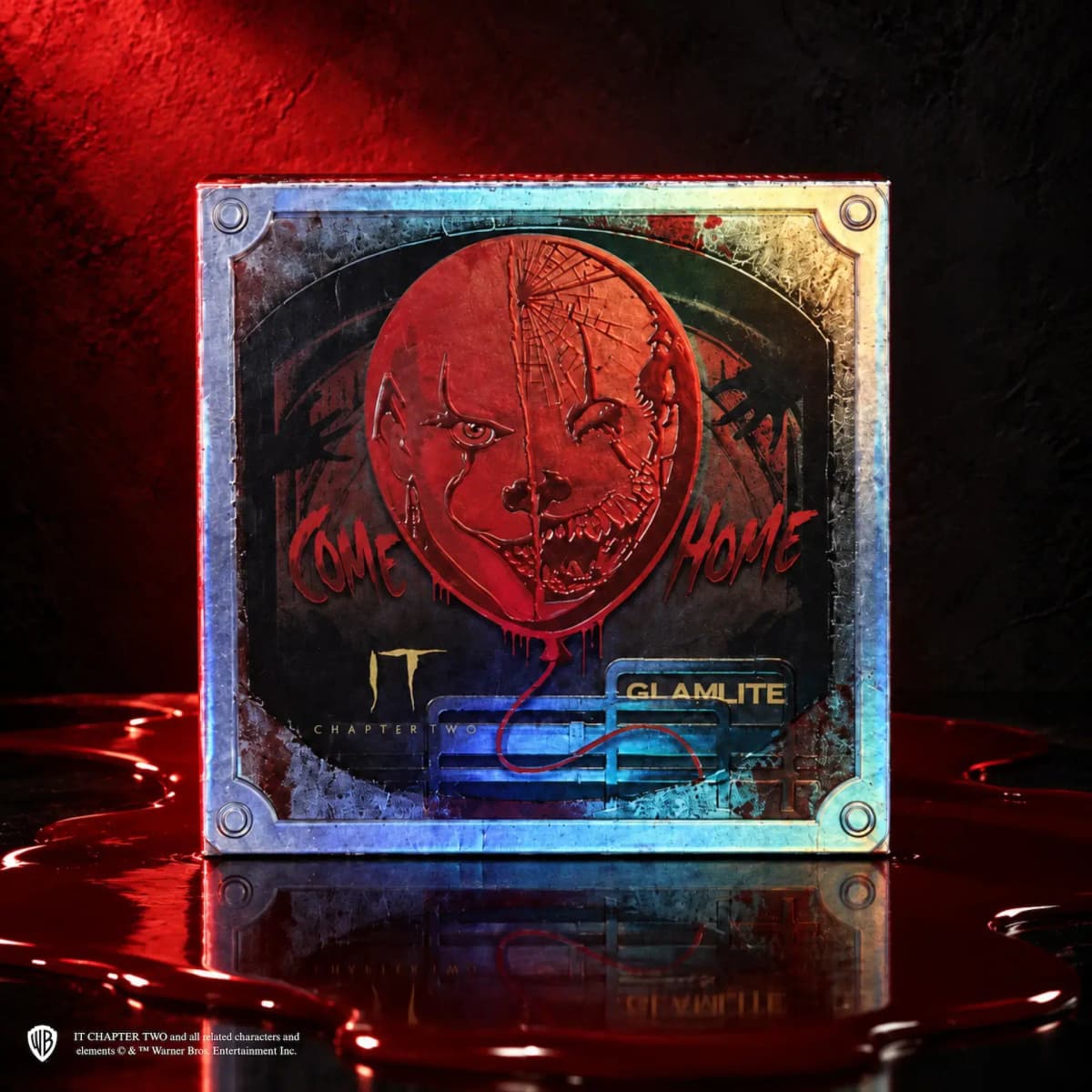 Holographic box with a red balloon split into Pennywise faces, 'Come Home' text, and IT Chapter Two and Glamlite logos