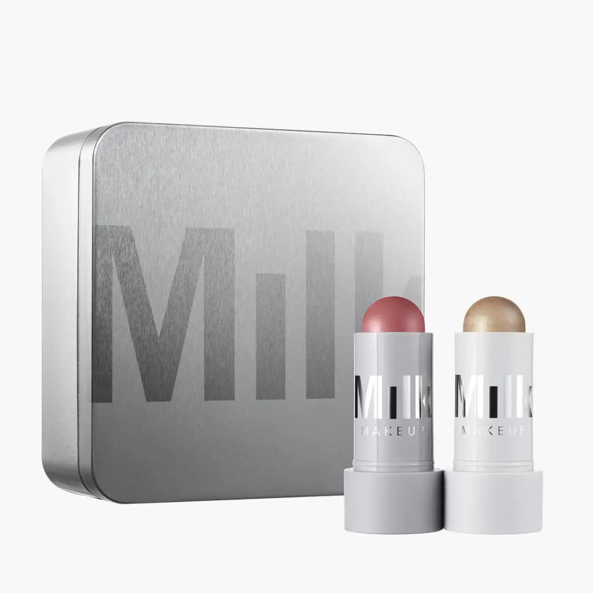It's Lit kit: silver Milk tin with a mauve pink cheek stick and a champagne highlighter stick