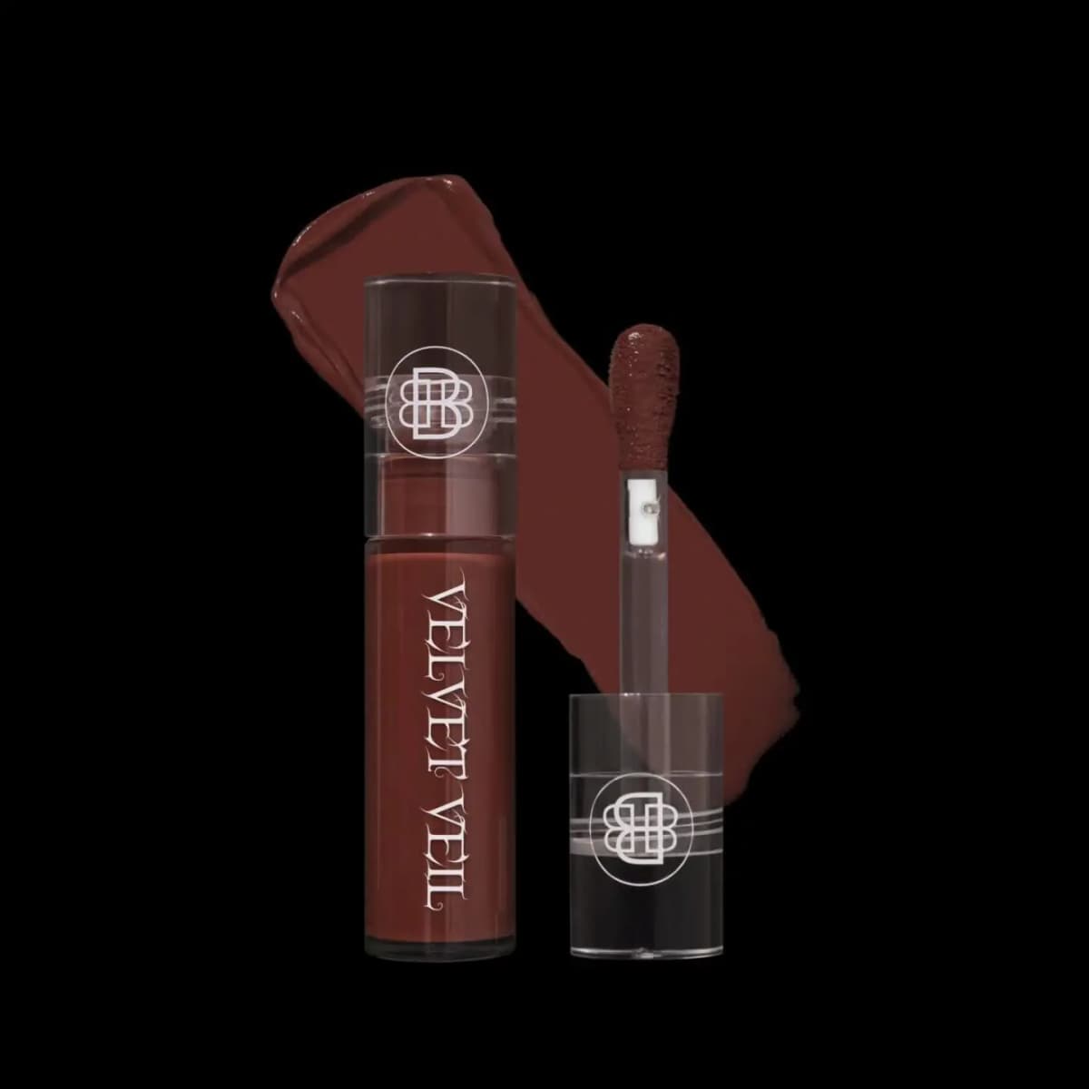 Deep brick-red brown lip mud with doe-foot applicator and glossy swatch on a black background