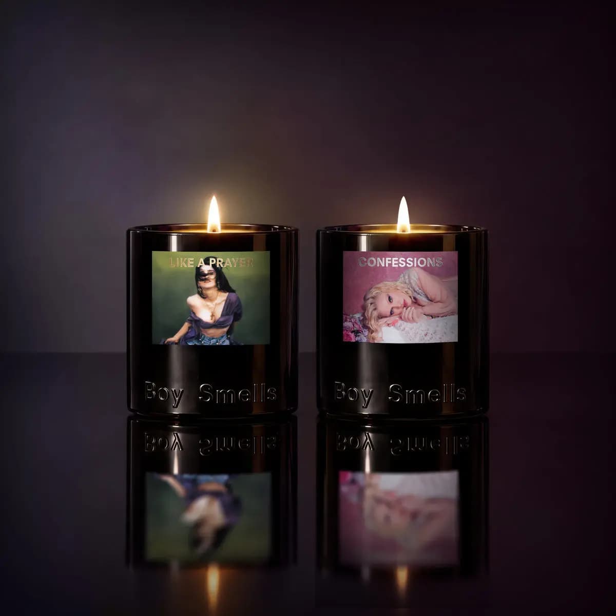 Lit Like a Prayer and Confessions candles glowing side by side against a dark purple backdrop with reflections
