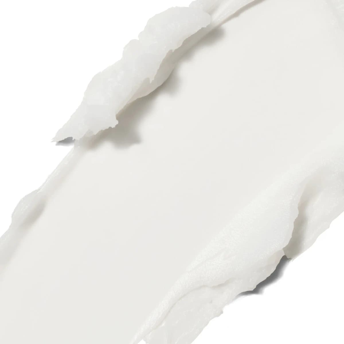 Close-up swatch of smooth, opaque white cleansing balm spread in a thick creamy streak