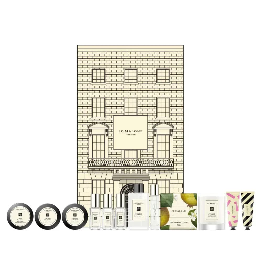 Closed Jo Malone London townhouse box with balcony and arched door, its twelve miniature products lined up in front
