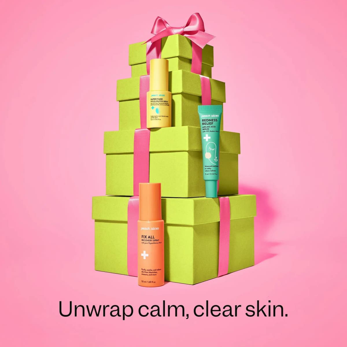 Super Fade, Redness Relief and Fix All stand on stacked lime gift boxes with pink ribbon: "Unwrap calm, clear skin.